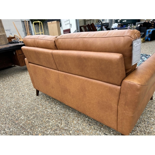 189 - A modern tan brown leather two seat sofa with adjustable head supports