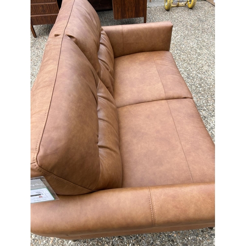 189 - A modern tan brown leather two seat sofa with adjustable head supports