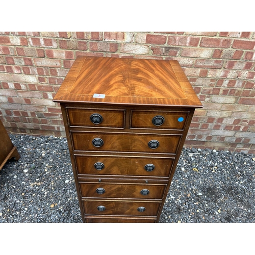 2 - A reproduction mahogany batchelors chest of seven drawers with leather slide 50x40x116