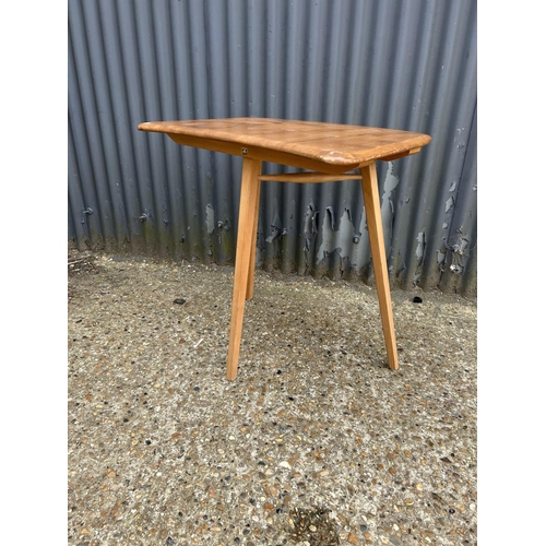 213 - A mid century ercol three leg writing table