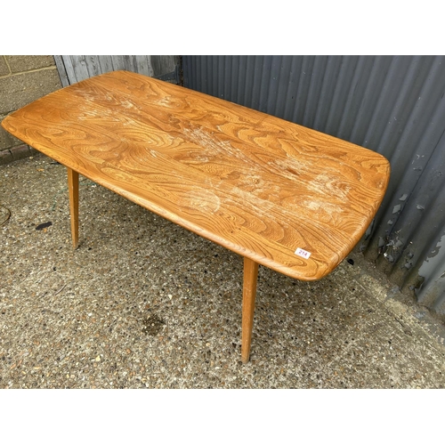 214 - An ercol light elm plank top dining table