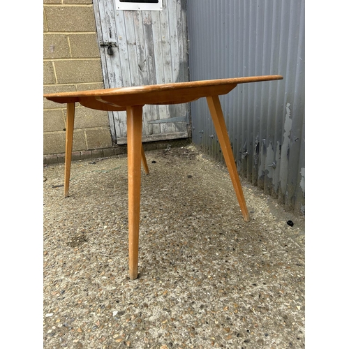 214 - An ercol light elm plank top dining table