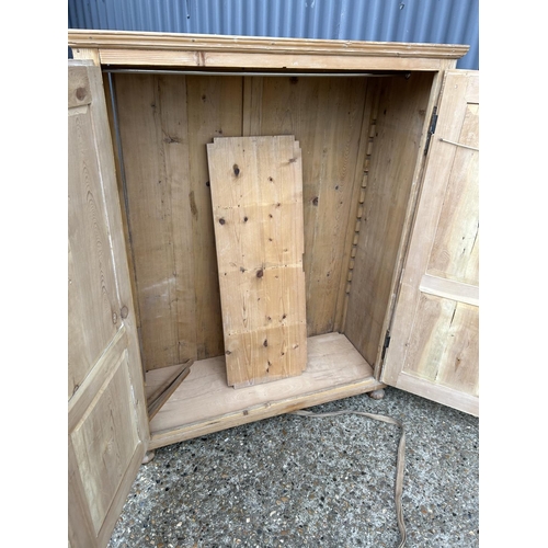 219 - A country pine two door larder cupboard with shelf 123x50x158