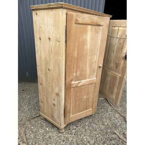 219 - A country pine two door larder cupboard with shelf 123x50x158