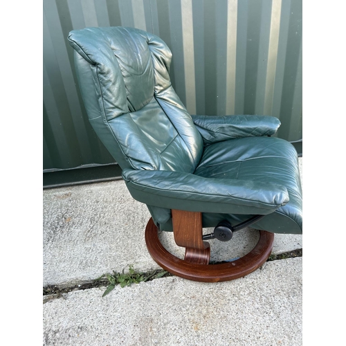 22 - An ekornes STRESSLESS GREEN leather easy chair with stool