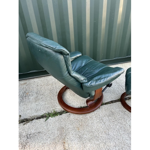 22 - An ekornes STRESSLESS GREEN leather easy chair with stool