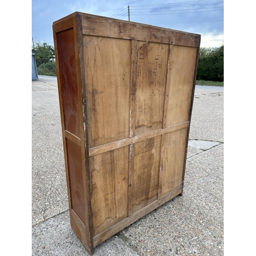 227 - A large 1920s oak three section tambour front office cupboard with all shelves (rollers appear compl... 