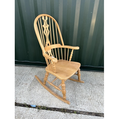 23 - A farmhouse style pine rocking chair