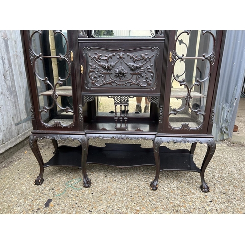 234 - A large Edwardian carved mahogany 'creeping death' cabinet, two glazed cabinet compartments, central... 