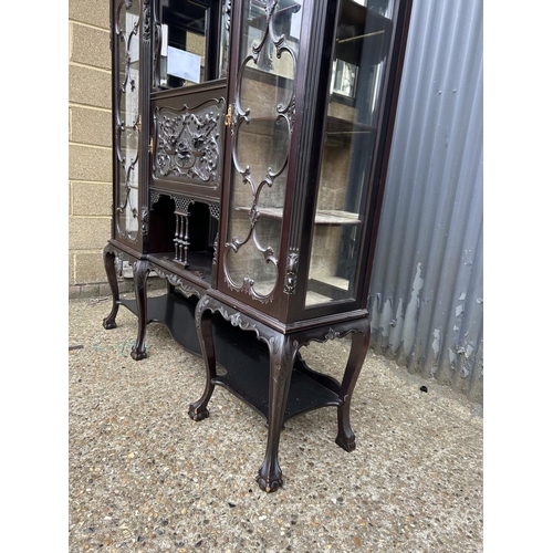 234 - A large Edwardian carved mahogany 'creeping death' cabinet, two glazed cabinet compartments, central... 