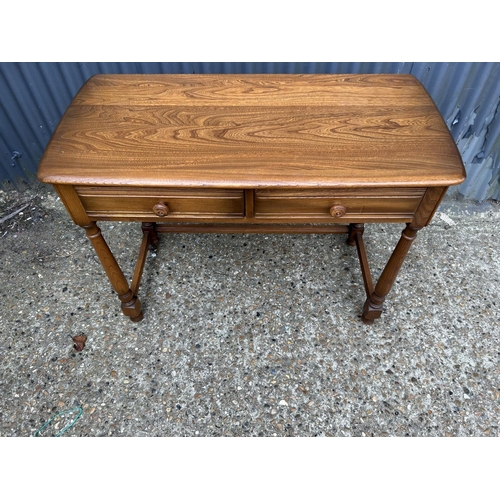 236 - An ercol golden dawn two drawer writing table 102x48x75