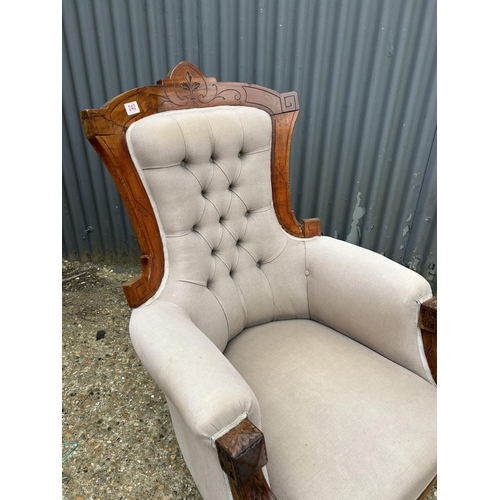 242 - A Victorian mahogany framed armchair with brown buttoned upholstery