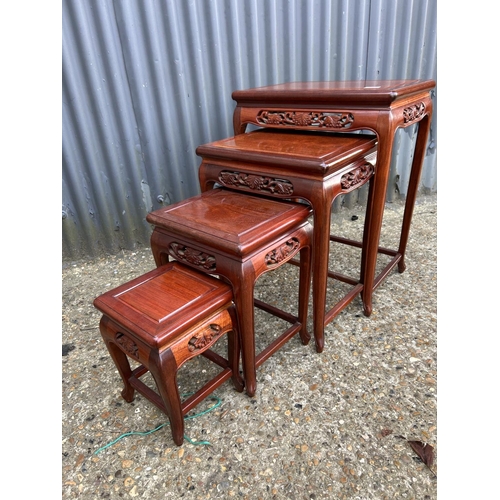 246 - An oriental hardwood nest of four occasional tables