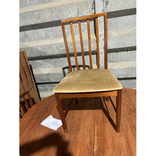 265 - A mid century oval g plan teak extending table with four chairs together