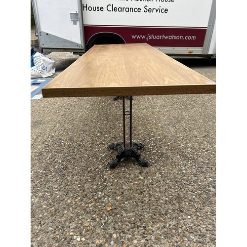 275 - A large light oak refectory table with twin  cast iron supports 240x83