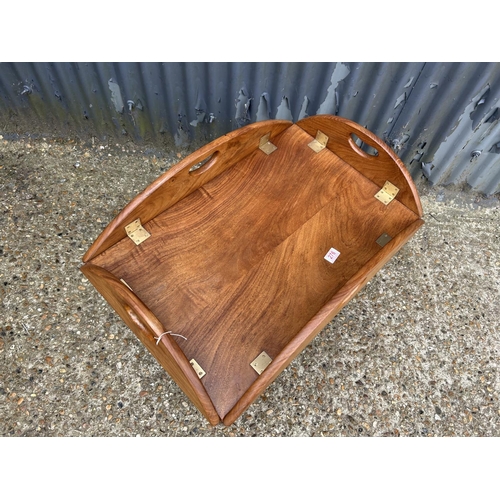 276 - A reproduction mahogany tray top military style coffee table