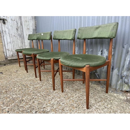 277 - A set of four mid century GPlan teak dining chairs with original green upholstery