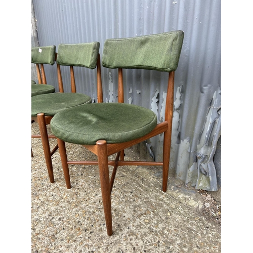 277 - A set of four mid century GPlan teak dining chairs with original green upholstery