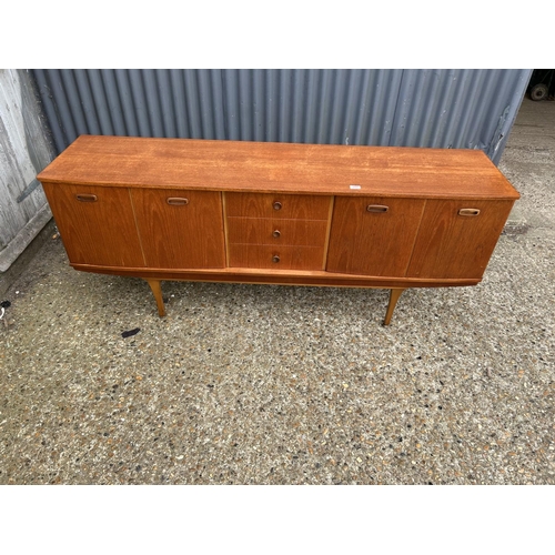 280 - A mid century teak sideboard by STONEHILL with concealed cocktail compartment