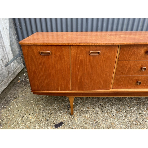 280 - A mid century teak sideboard by STONEHILL with concealed cocktail compartment