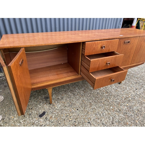 280 - A mid century teak sideboard by STONEHILL with concealed cocktail compartment