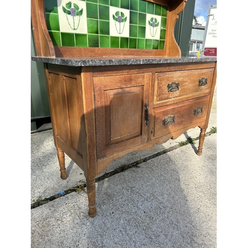 295 - An Edwardian washstand with green tiled back and marble top