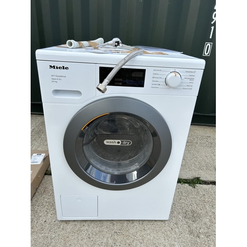 307 - A MEILE Wt1 excellence washer drier with handbook and under counter mounting kit