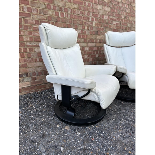 311 - A pair of white leather EKORNES stressless white leather reclining armchairs