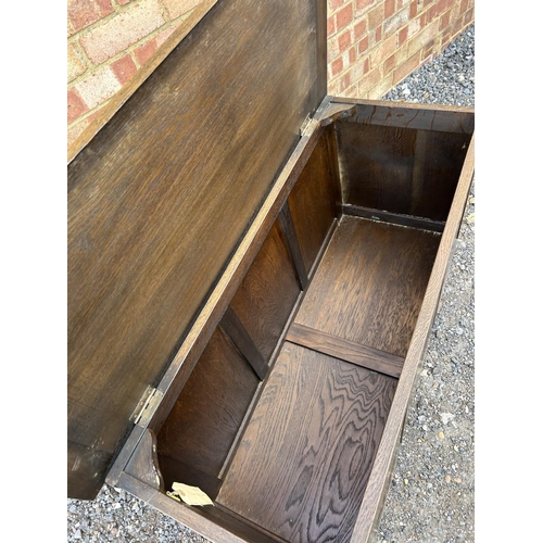 314 - A carved oak three panel blanket box chest