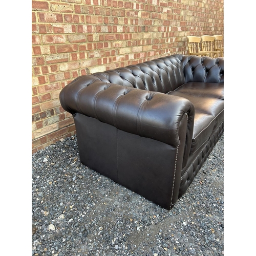 320 - A brown leather chesterfield three seater sofa