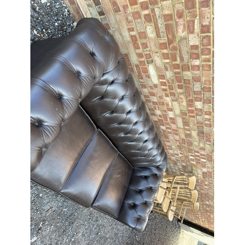 320 - A brown leather chesterfield three seater sofa