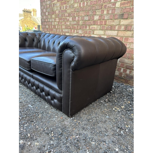 320 - A brown leather chesterfield three seater sofa