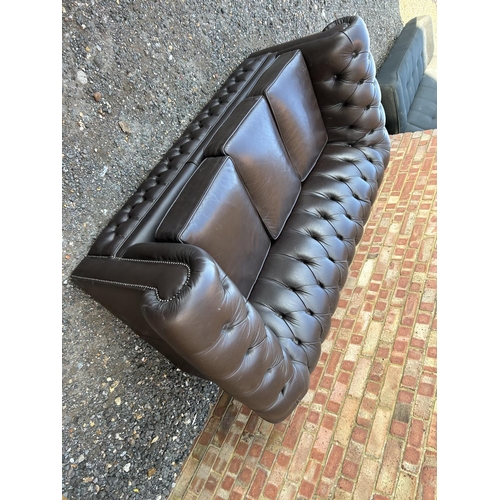 320 - A brown leather chesterfield three seater sofa