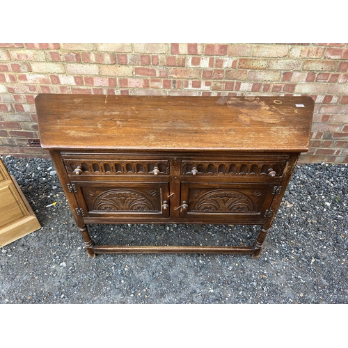 323 - A carved oak sideboard with two drawers and two doors 145x 50x85