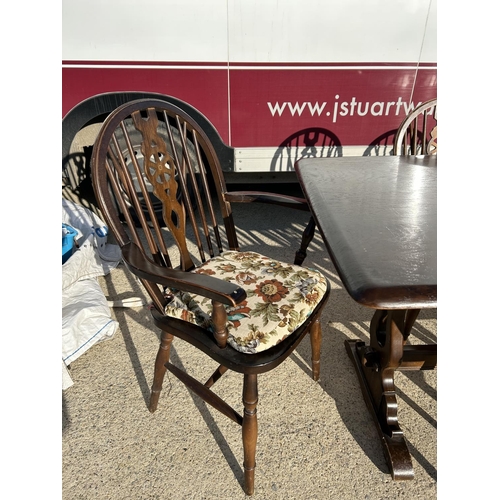 351 - An ercol style refectory dining table together with a set of 6 wheelback chairs (inc. 2 carvers)