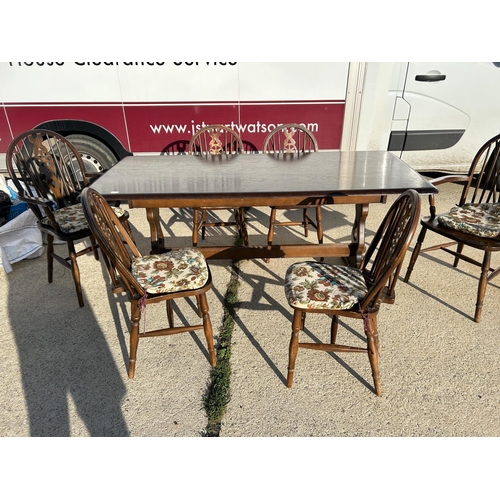 351 - An ercol style refectory dining table together with a set of 6 wheelback chairs (inc. 2 carvers)