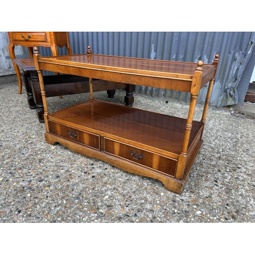 47 - A two drawer hall table together with a yew coffee table with drawers and a oak coffee table