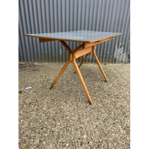 48 - An unusual mid century kitchen table with grey formica top and splayed legs possibly BY KANDYA 67x12... 