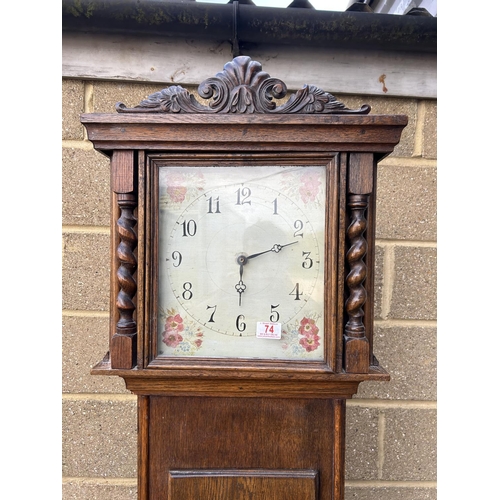 74 - An oak cased longcase clock with floral painted dial