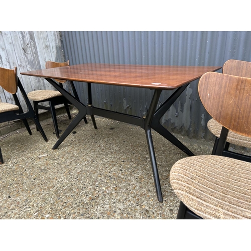 80 - A 1950's g plan teak dining table with 'spider support' and four butterfly back chairs