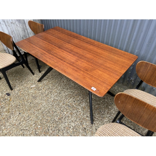 80 - A 1950's g plan teak dining table with 'spider support' and four butterfly back chairs