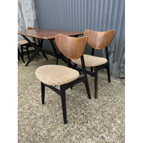 80 - A 1950's g plan teak dining table with 'spider support' and four butterfly back chairs