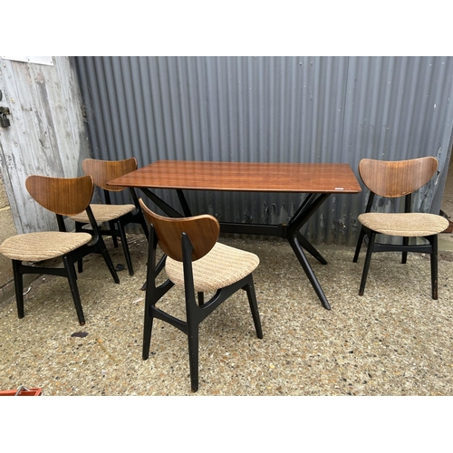 80 - A 1950's g plan teak dining table with 'spider support' and four butterfly back chairs