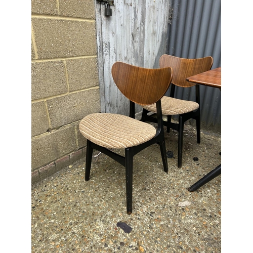 80 - A 1950's g plan teak dining table with 'spider support' and four butterfly back chairs