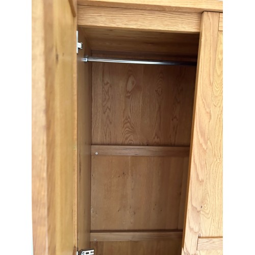 110 - A pair of light oak double wardrobes with drawer (currently dismantled)