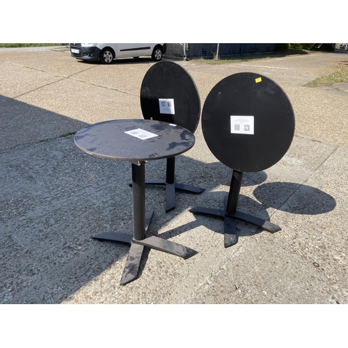 238 - Three circular tilt top cafe / pub tables 60cm diameter