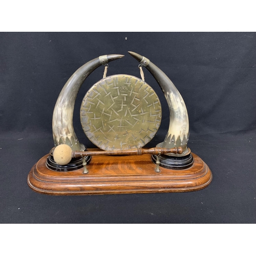 588 - Edwardian horn and oak dinner gong on stand with brass gong marked Burmese, width 47cms, height 32cm... 