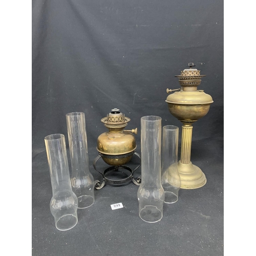 899 - Two brass oil lamps and four chimneys