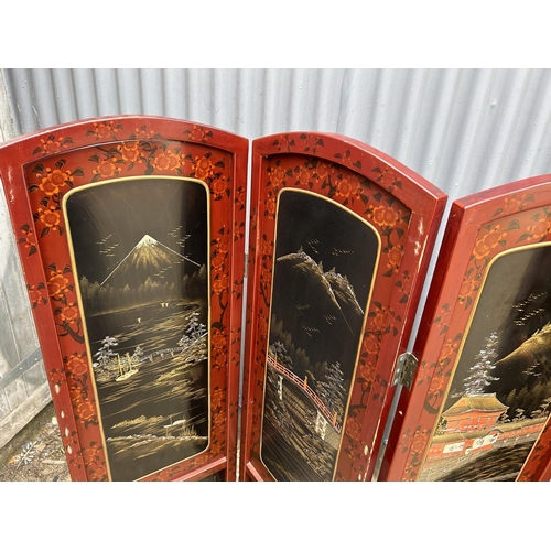 11 - A four section oriental laquered screen 137cm tall