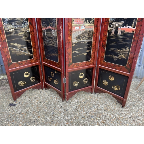 11 - A four section oriental laquered screen 137cm tall